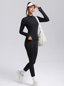DefineSculpt Stand-Collar Zip Jacket — dark zip jacket styled with black leggings and a white cap