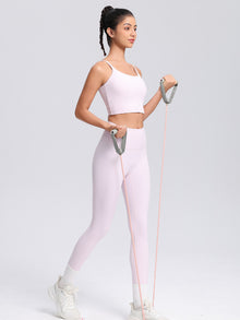 SecondSkin Sculpt Leggings — pale pink leggings shown with a resistance band