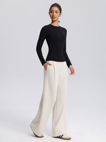 SecondSkin Long-Sleeve Training Top — black long-sleeve top styled with cream wide-leg pants